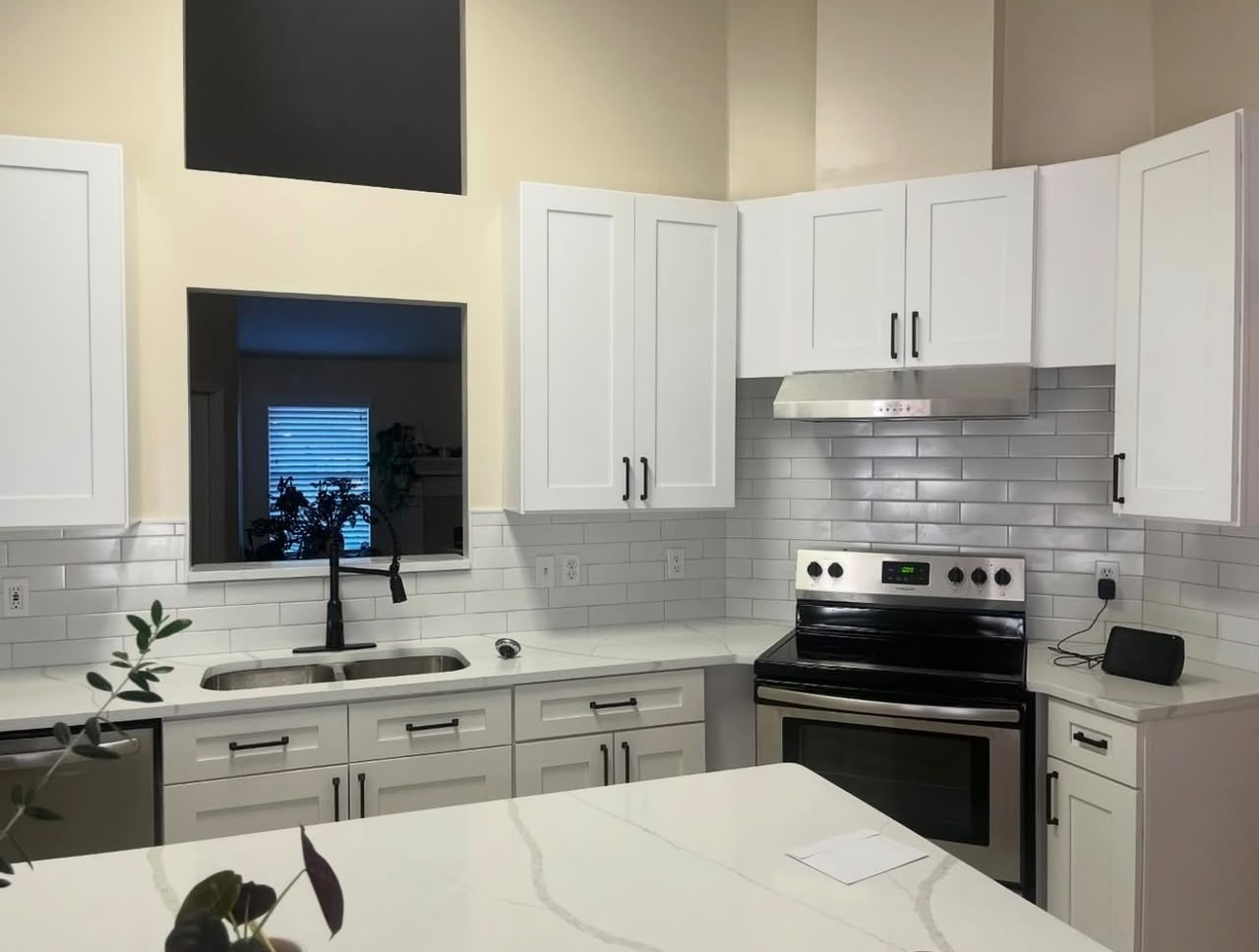 Modern kitchen at night with quartz island
